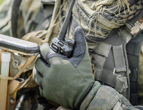 Camo Glove holding a walkie talkie