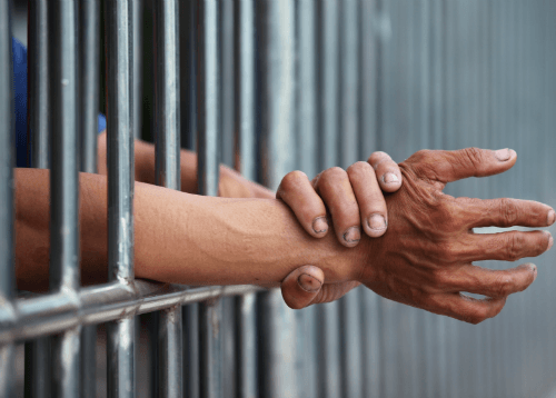 Hands through Cell Bars