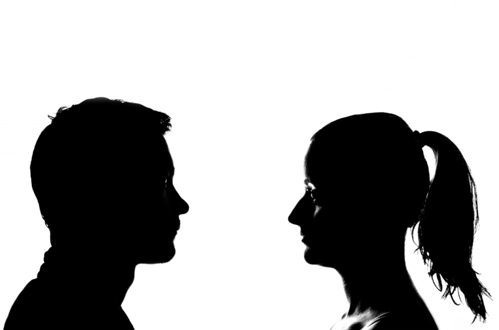silhouette of a man and a women facing eachother