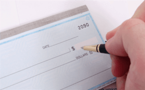 Soldier writing a check