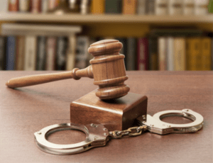Gavel and handcuffs in a military courtroom