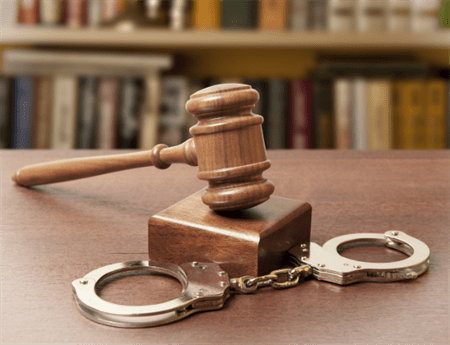 Gavel and handcuffs in a military courtroom