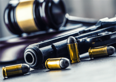 A court gavel with guns and bullets