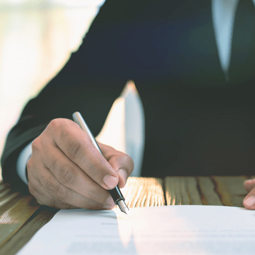 A man writing a statement on an official document