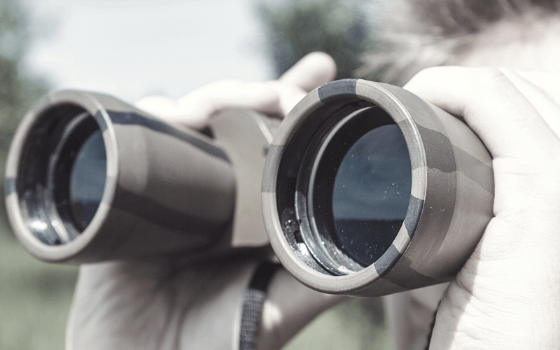 Military lookout, looking through binoculars