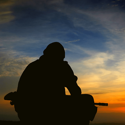 Soldier alone in silhouette during sunset