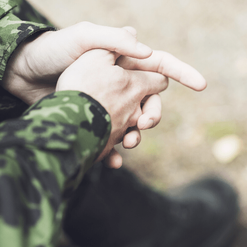 a military members hands folded