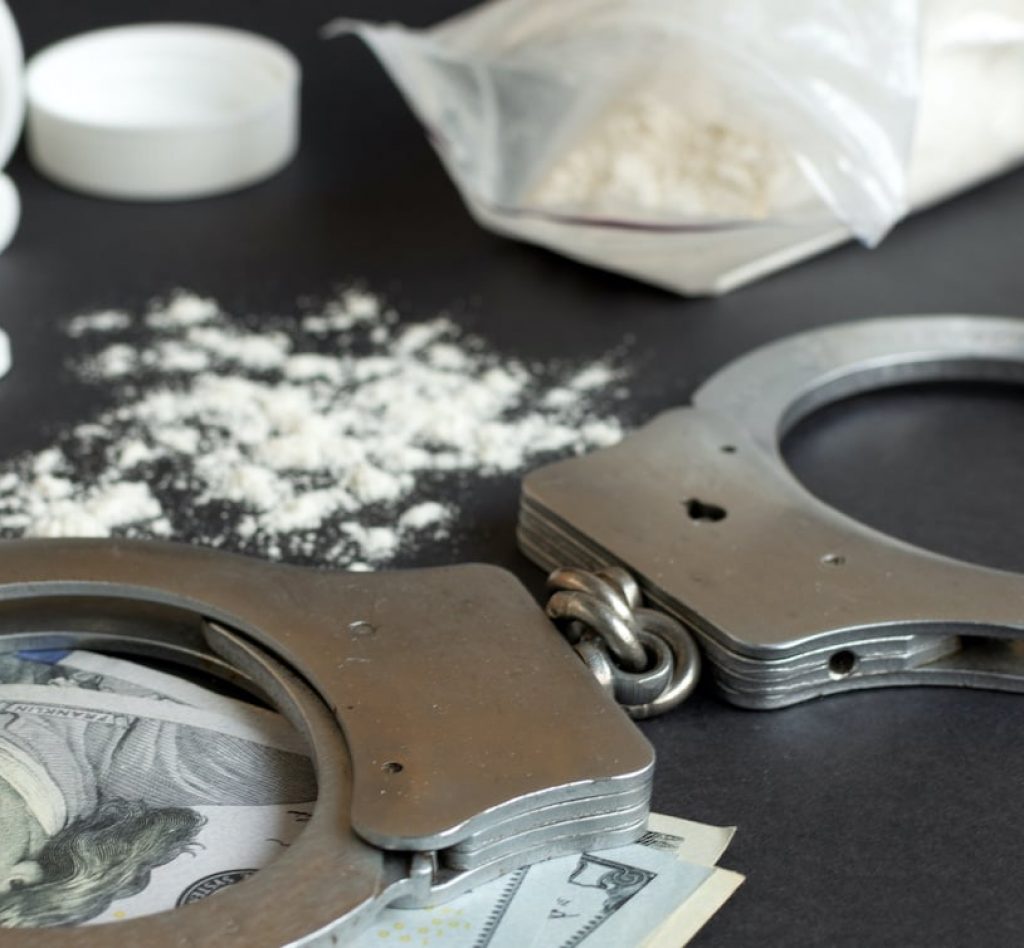Drugs-and-handcuffs-sized Drugs-and-handcuffs-sized