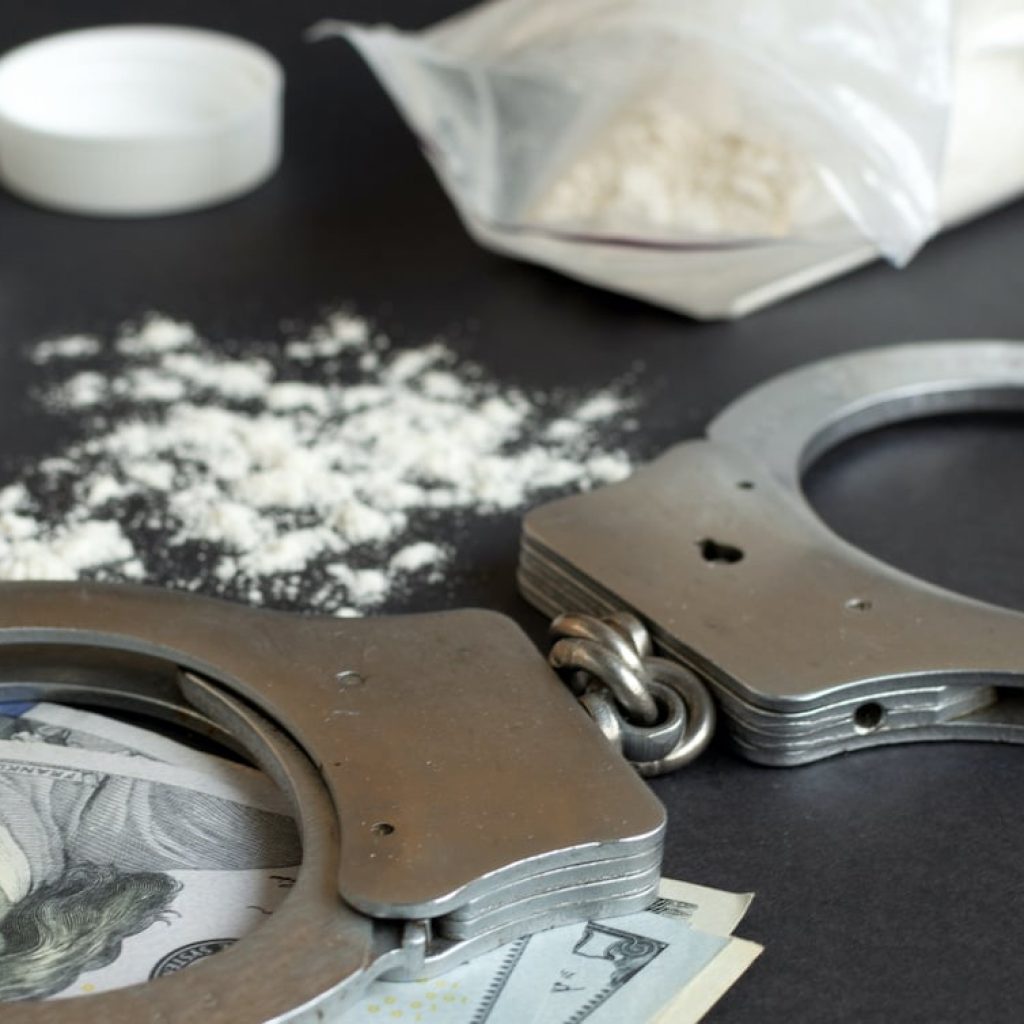 Drugs-and-handcuffs-sized Drugs-and-handcuffs-sized